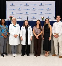Diverse group of healthcare professionals and participants exuding positivity and unity at a community health event.