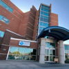 Modern building with large glass windows and curved awning, suggesting professionalism, openness, and a welcoming atmosphere.
