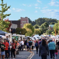 Lively outdoor market with colorful stalls, bustling crowds, and a joyful atmosphere full of community spirit and celebration.