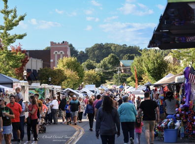 Lively outdoor market with colorful stalls, bustling crowds, and a joyful atmosphere full of community spirit and celebration.