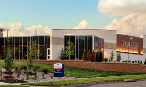 Modern building with glass windows and inviting landscaping, exuding professionalism, trust, and community focus.