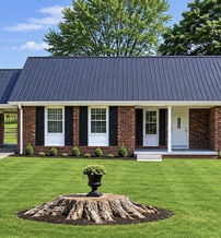 Charming one-story home with a sloped roof, brick, white columns, and a lush lawn, evoking warmth and nostalgia.