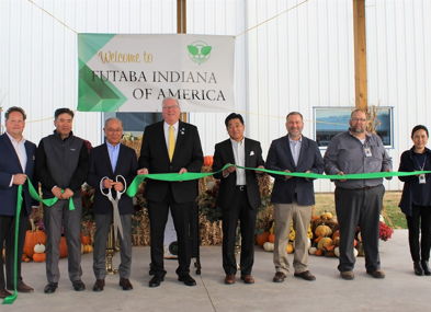 Ribbon-cutting ceremony for [Company Name] in Indiana, featuring excitement, optimism, and a festive autumn backdrop.