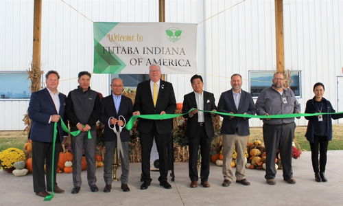 Ribbon-cutting ceremony for [Company Name] in Indiana, featuring excitement, optimism, and a festive autumn backdrop.