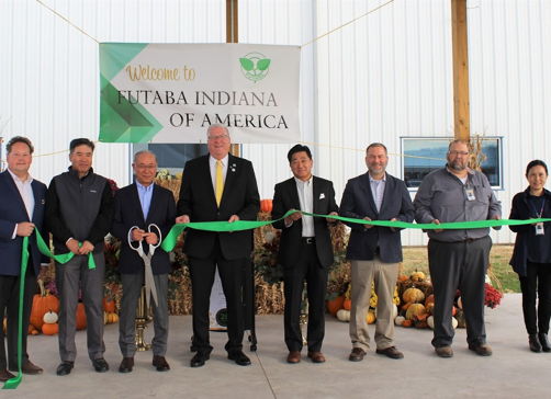 Ribbon-cutting ceremony for [Company Name] in Indiana, featuring excitement, optimism, and a festive autumn backdrop.