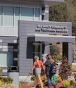 Group of diverse students mingling outside a community college, conveying excitement, camaraderie, and a sense of new beginnings.