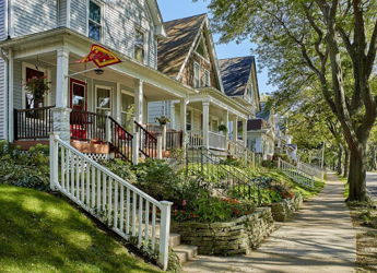 Charming street with classic homes, inviting porches, lush gardens, and a warm, tranquil neighborhood atmosphere.