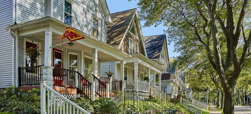 Charming street with classic homes, inviting porches, lush gardens, and a warm, tranquil neighborhood atmosphere.