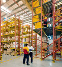 Warehouse scene with shelves of boxes, two workers discussing, bright colors, evoking productivity and teamwork in logistics.