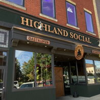 Image of Highland Social gastropub, featuring a modern brick design, large windows, and a warm, inviting atmosphere.