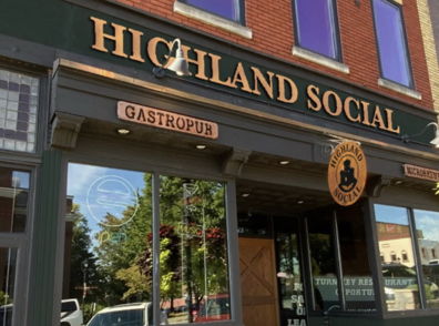 Image of Highland Social gastropub, featuring a modern brick design, large windows, and a warm, inviting atmosphere.