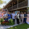 Joyful ribbon-cutting ceremony with diverse attendees celebrating a new establishment, showcasing community support and excitement.
